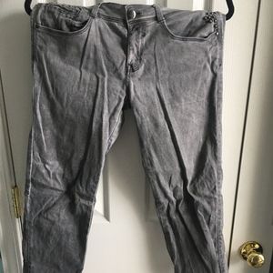 Grey denim jeans with silver rhinestones on pocket